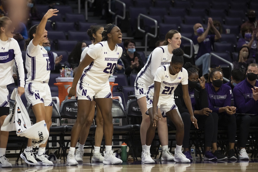 Players in white jerseys celebrate after a big play.