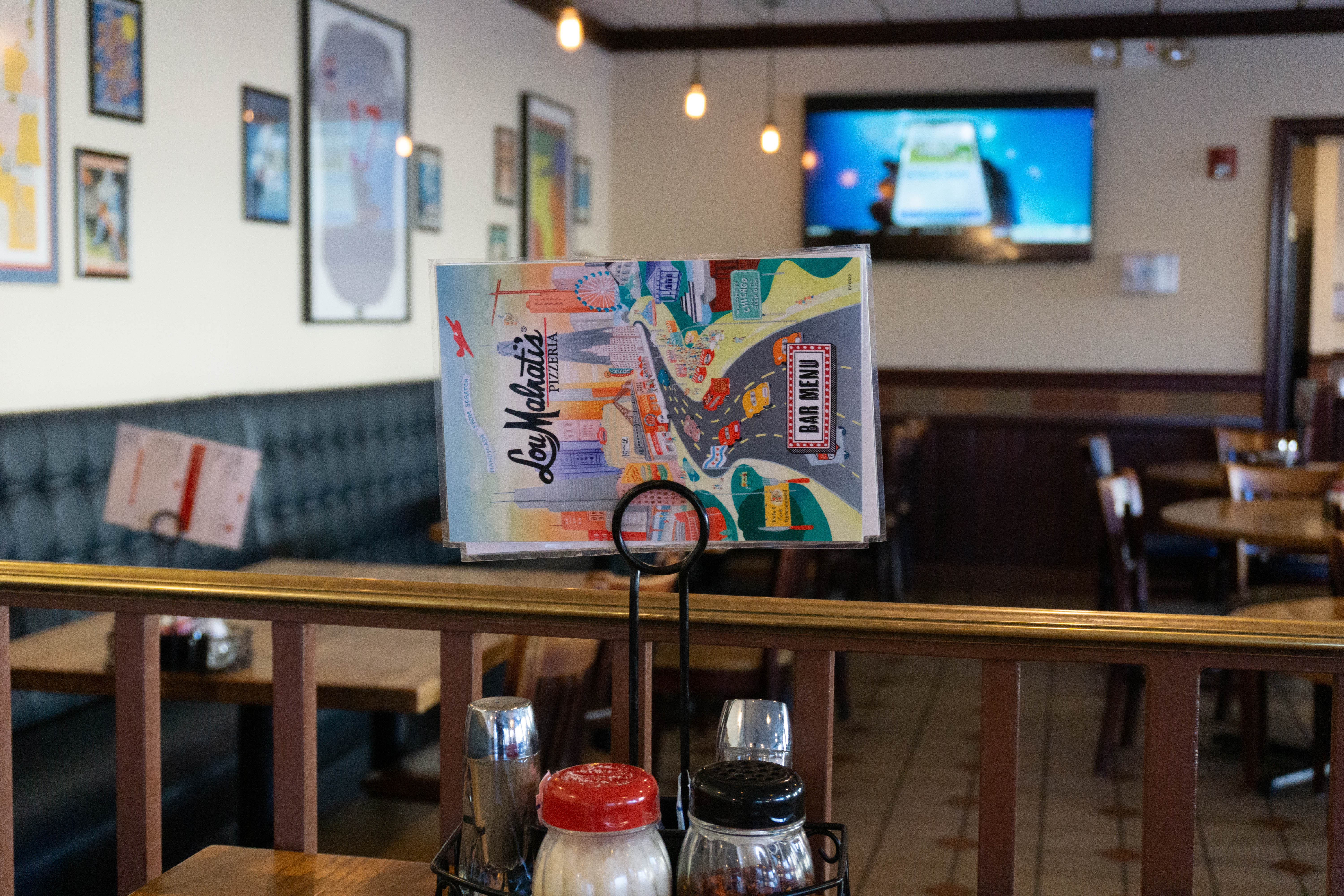 A plastic restaurant menu is displayed on a table.