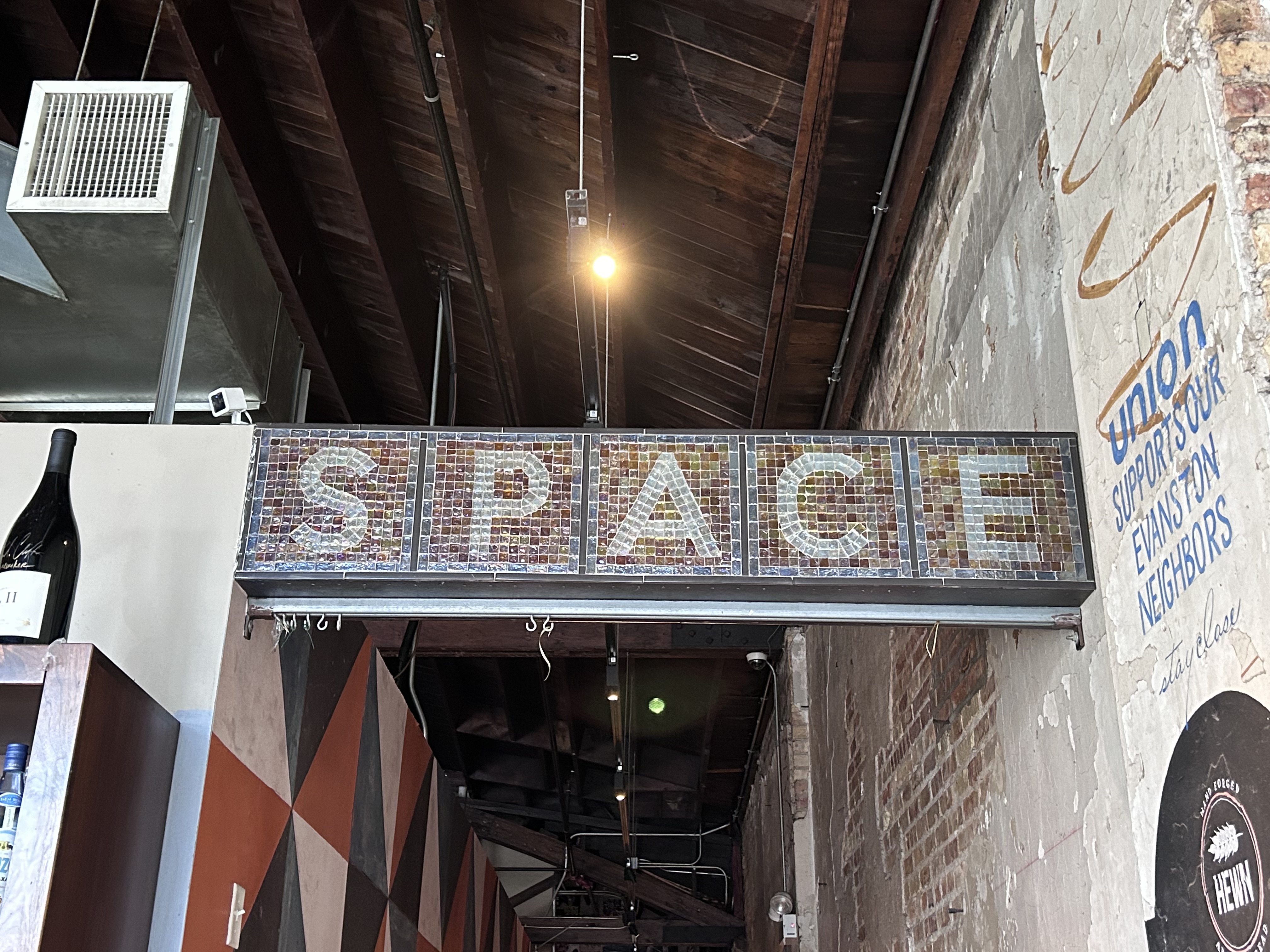 Rustic mosaic sign that says “SPACE.”